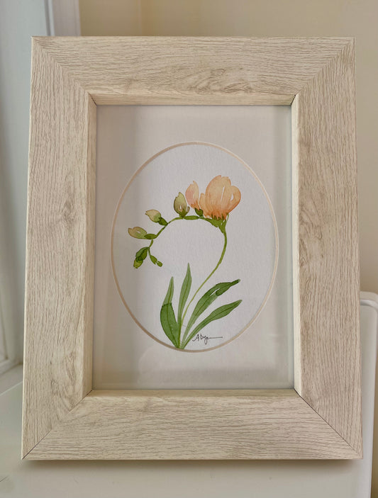 Framed artwork of a floral design on a neutral background